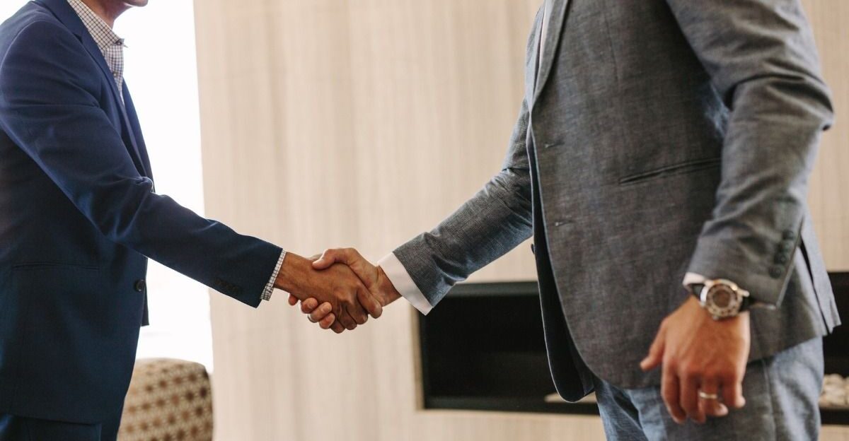 Business people hand shake in office by jannevdvegt