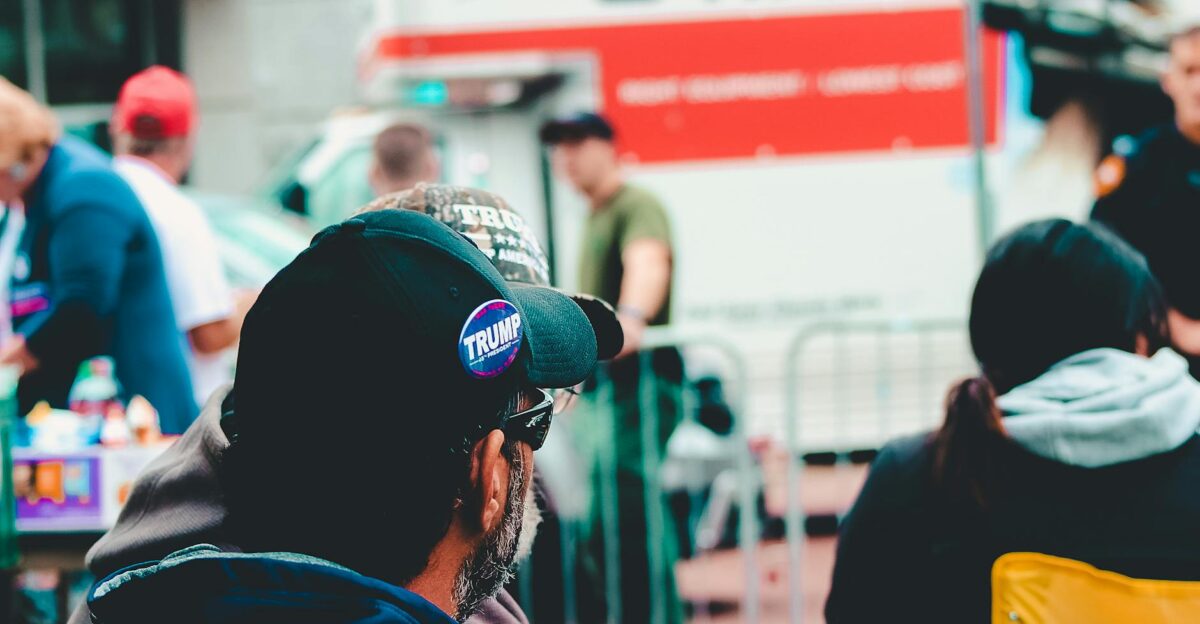 Participants at a political rally in Wheeling WV wearing campaign merchandise with a U-Haul in the background