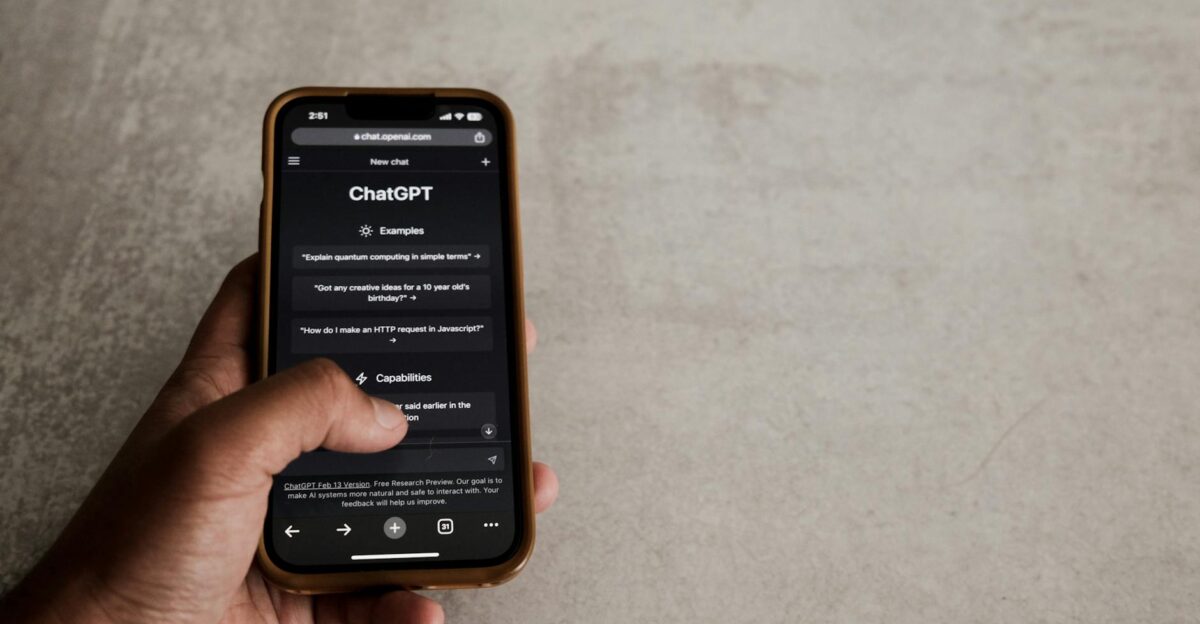 Close-up of a hand interacting with ChatGPT on a smartphone showcasing modern AI technology