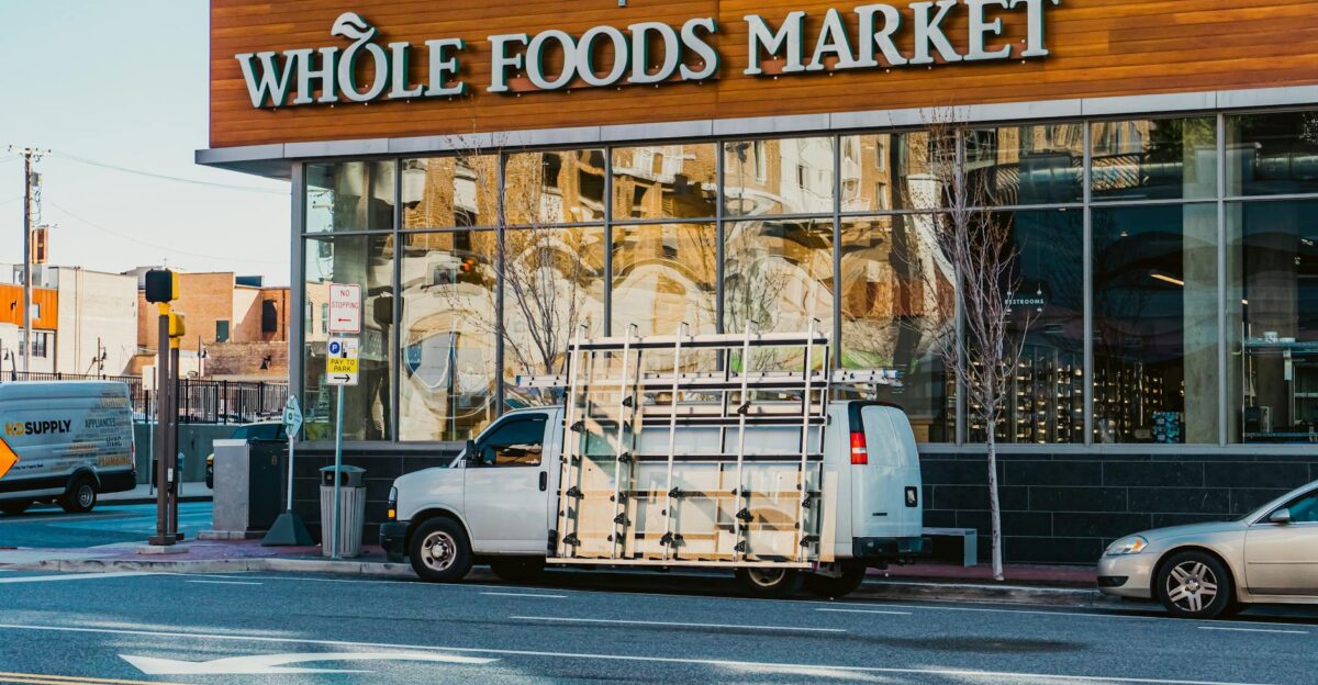 Image of Whole Foods Market with vehicles on a Baltimore street capturing urban life