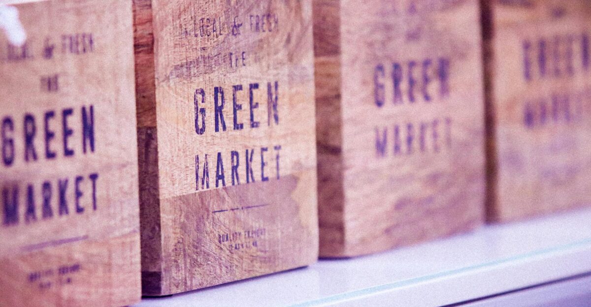 Close-up of vintage wooden boxes with green market text ideal for commerce themes