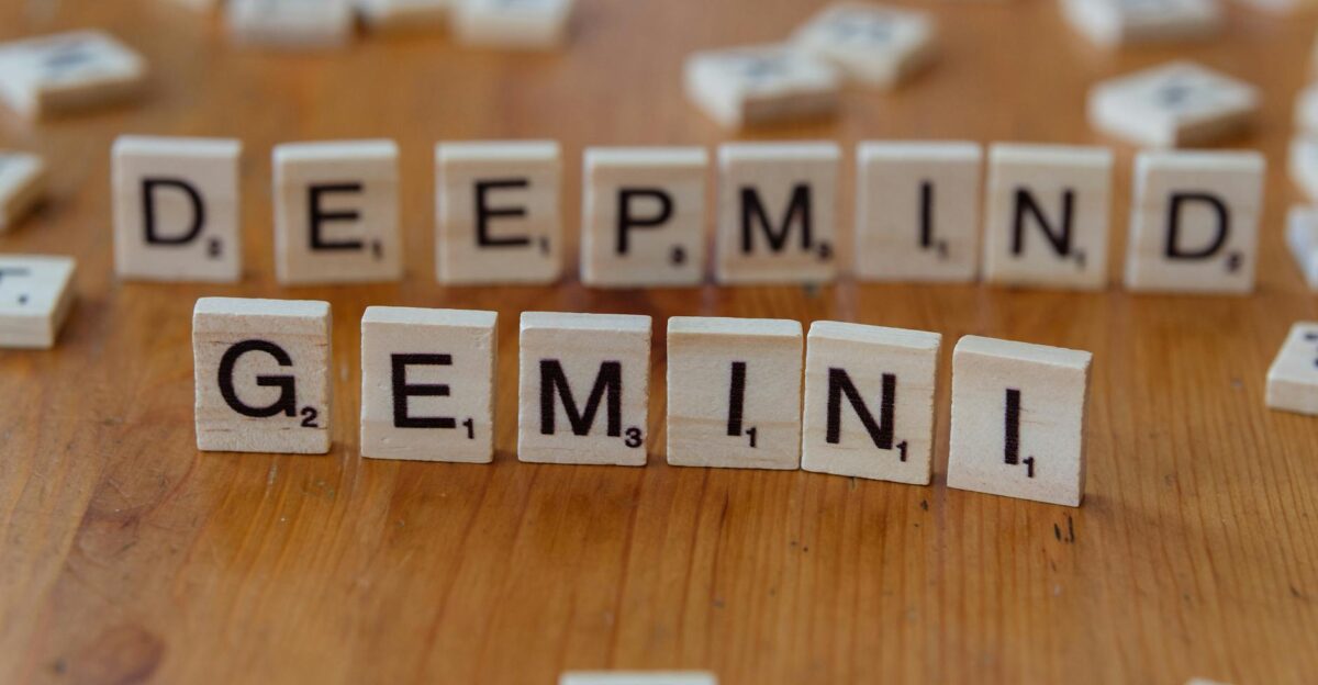 Wooden Scrabble tiles spelling Deepmind and Gemini on a wooden surface a concept of AI and games