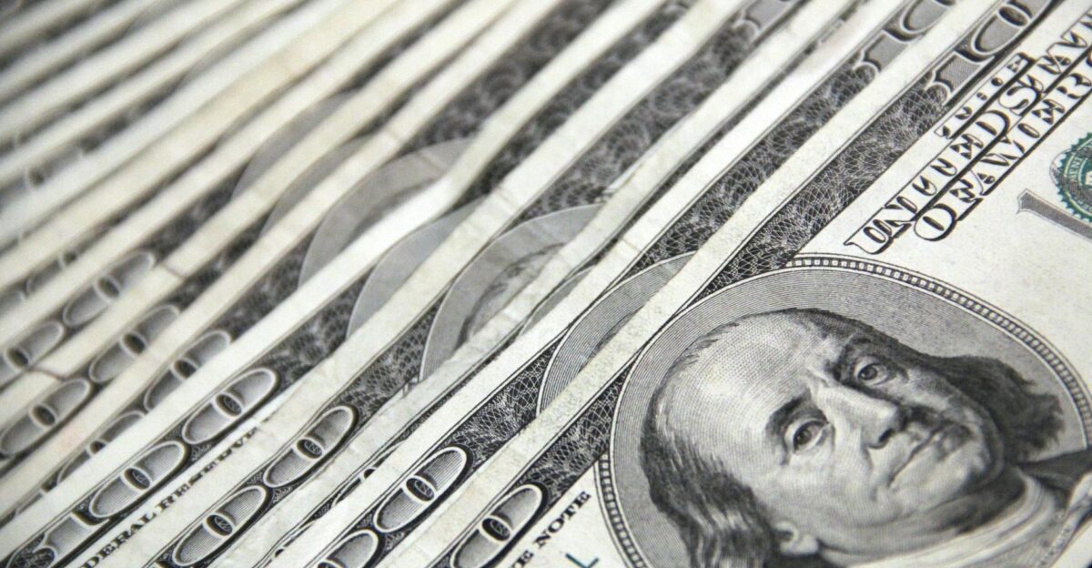 Detailed image showing a close-up of neatly stacked US dollar bills ideal for financial and economic themes
