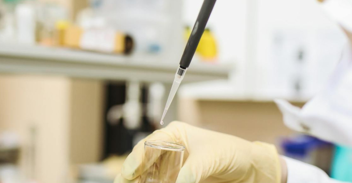 Scientist using a pipette for chemical analysis in a modern laboratory
