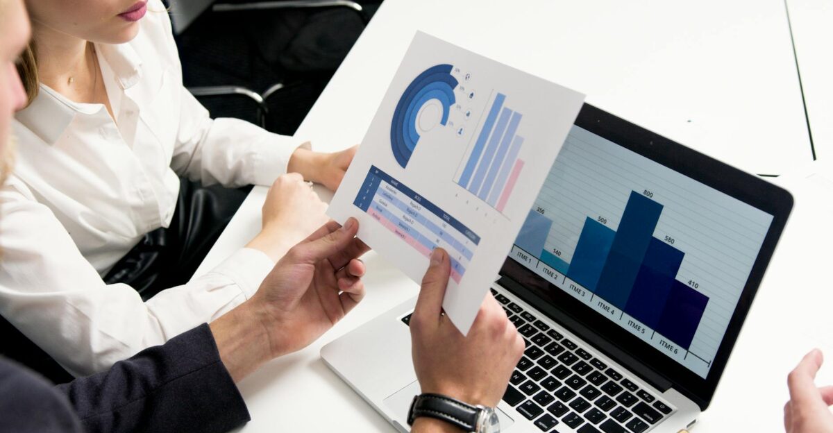 Business professionals discussing data charts and graphs in a modern office setting
