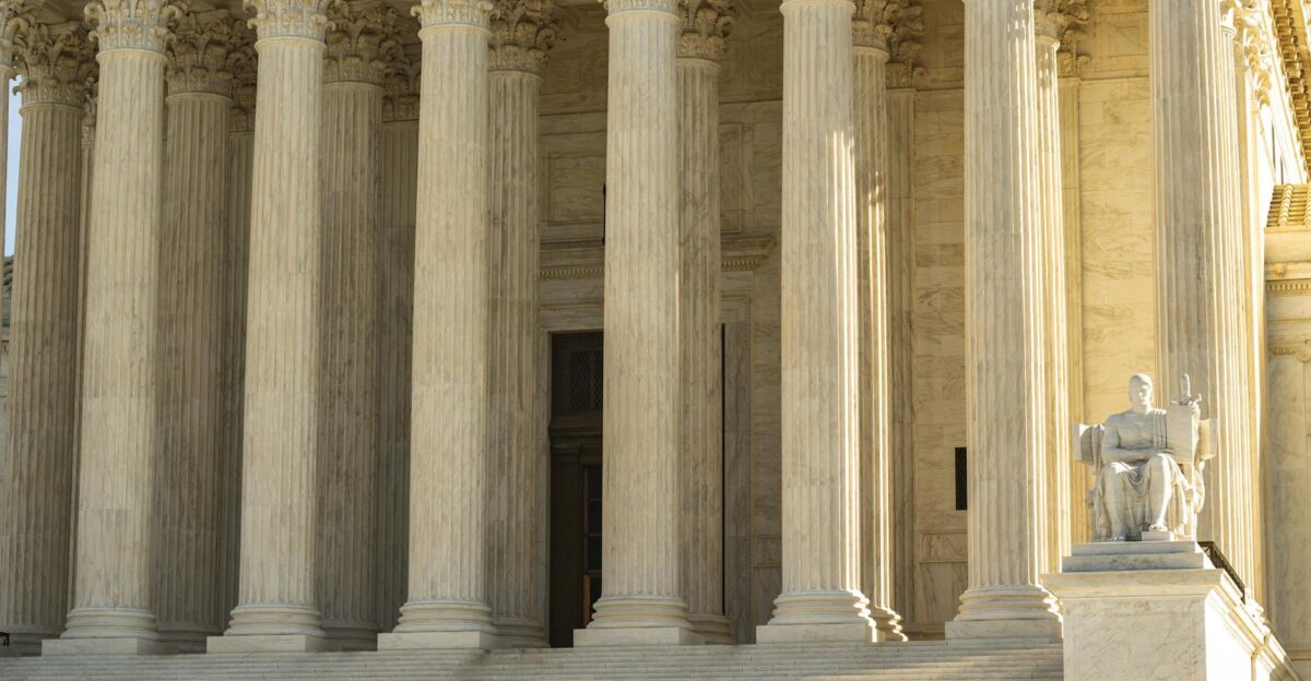 The Supreme Court of the United States with iconic marble columns and statue captured in natural light