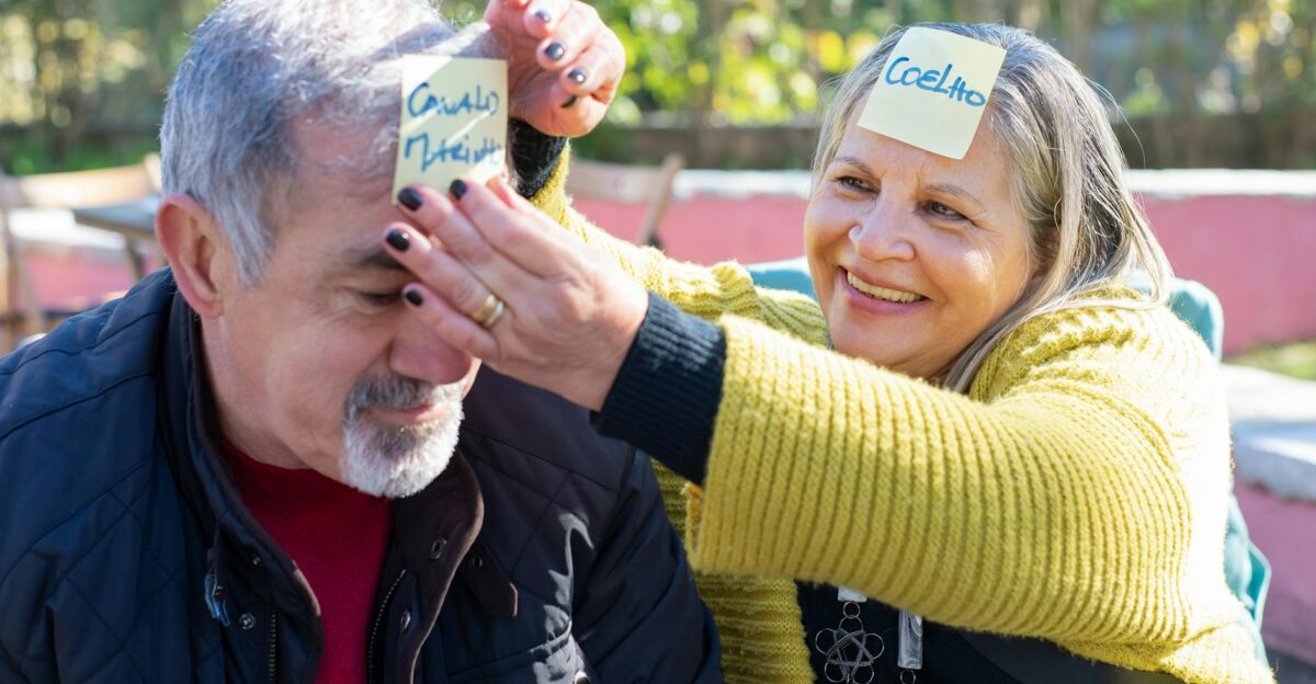 Joyful elderly couple playing a fun outdoor game with sticky notes in Portugal