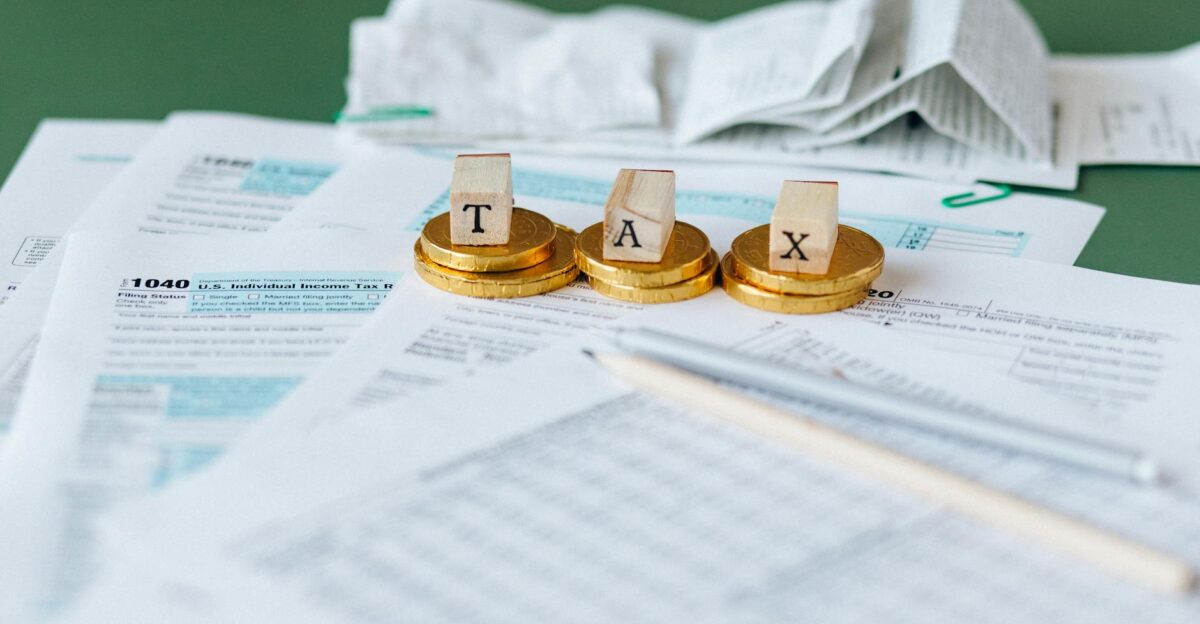 Close-up of tax forms receipts and coins symbolizing financial accounting and taxes