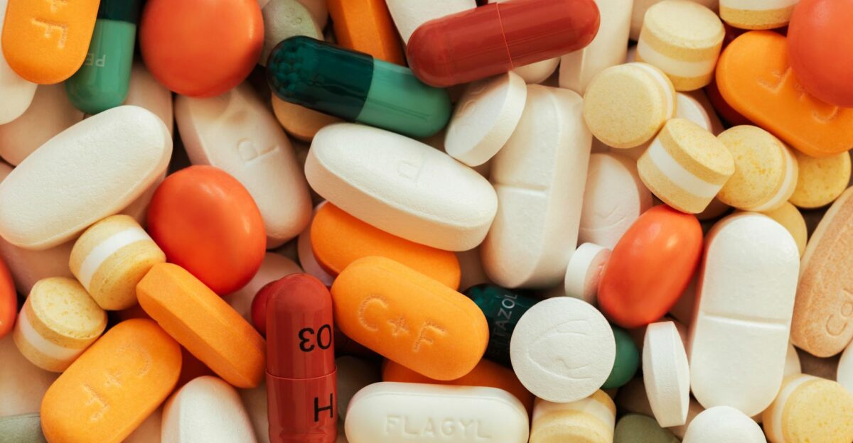 Close-up of assorted colorful pills and tablets on a surface