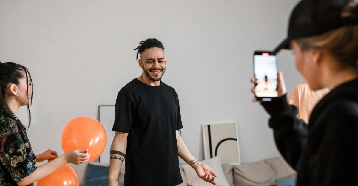 A group of friends filming a playful TikTok dance video indoors capturing joy and creativity