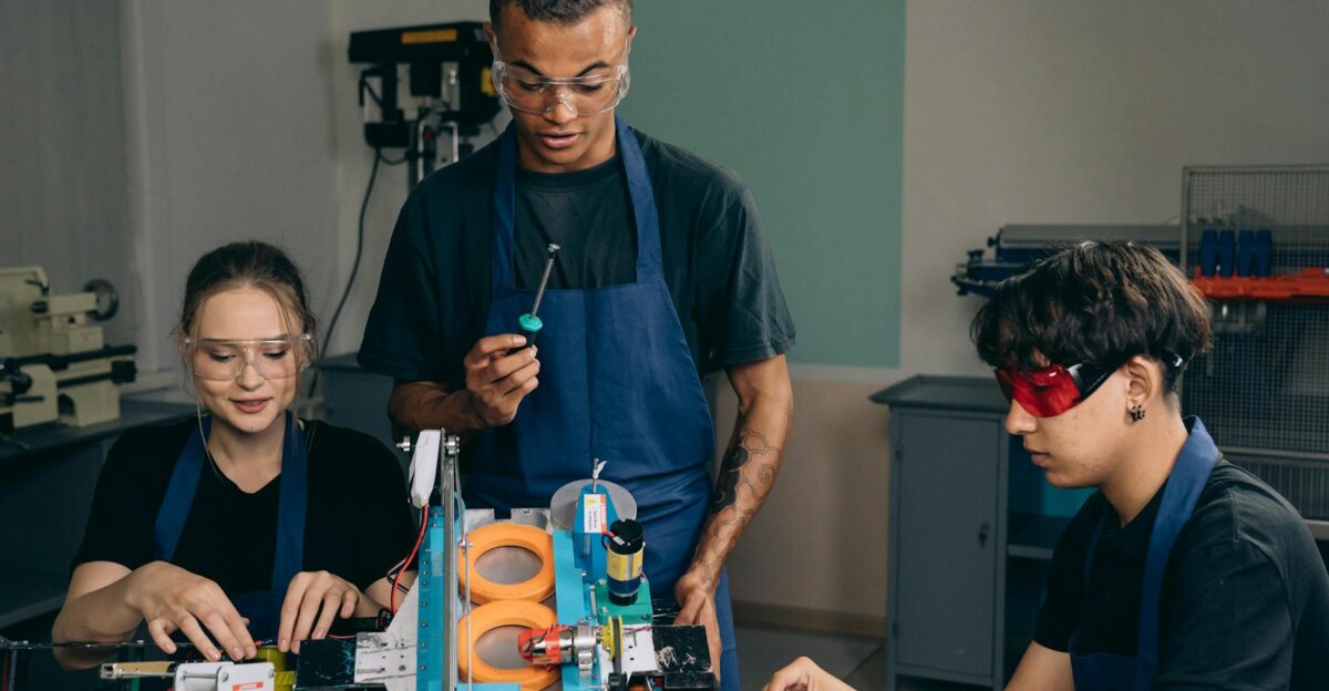 Engineering team working with tools and equipment in a modern workshop