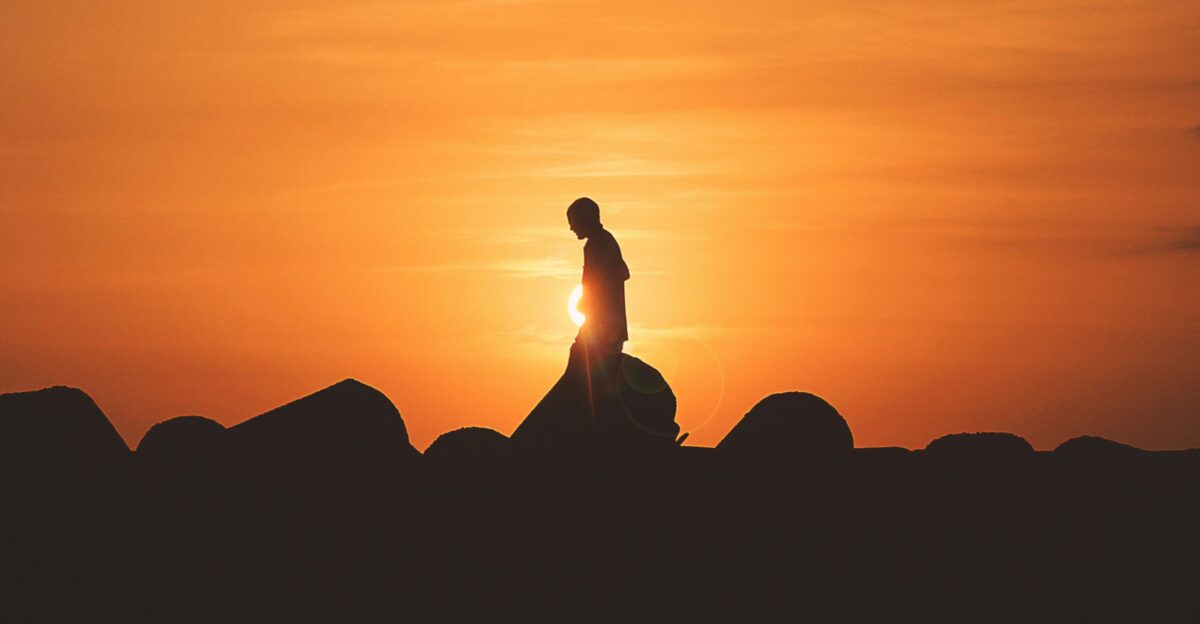 person standing on rock platform