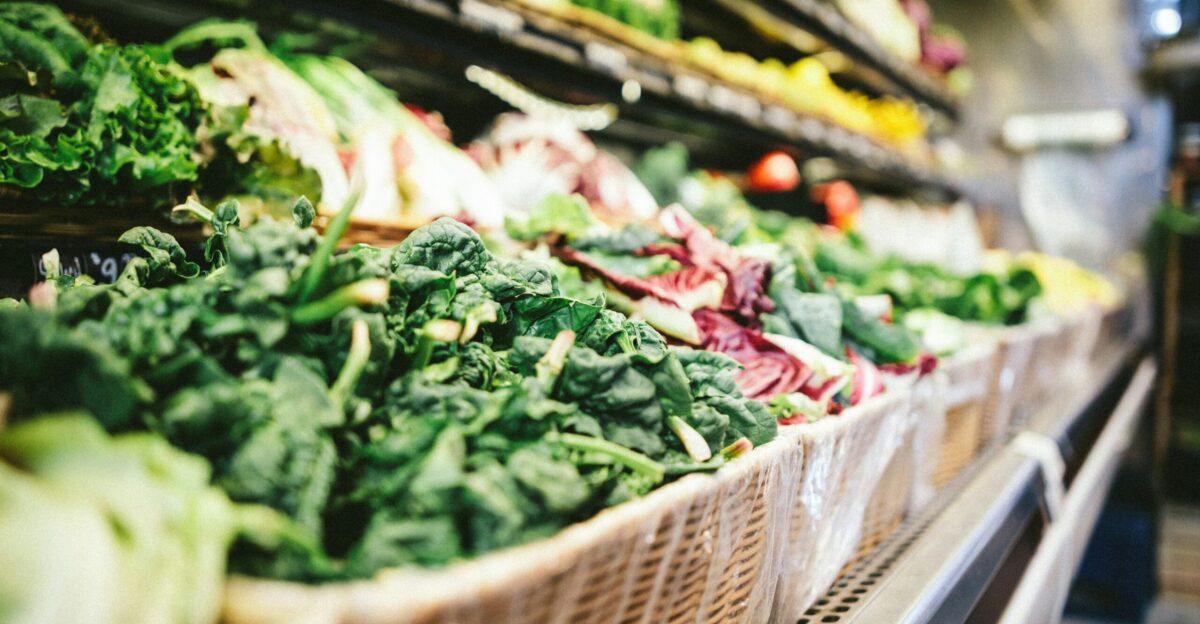 row of vegetables placed on multilayered display fridge