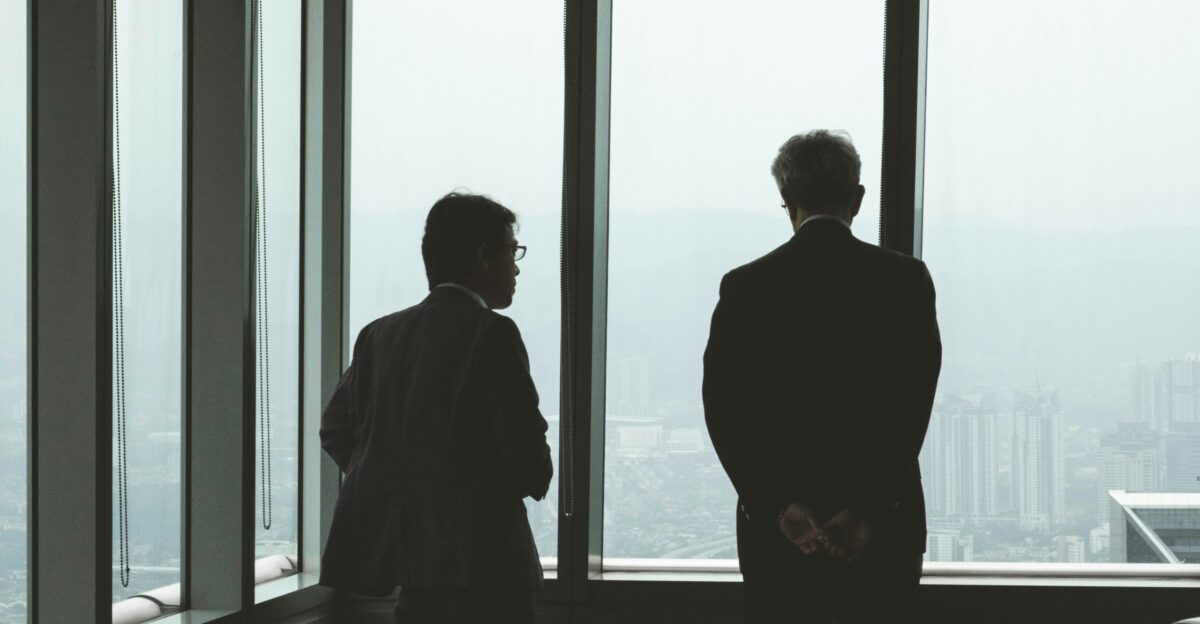 two men standing near window