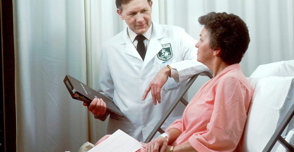man in white button up shirt holding black tablet computer