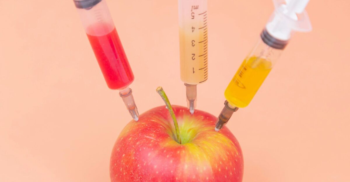 red apple beside clear glass bottle