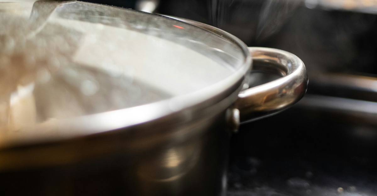 stainless steel cooking pot on black table