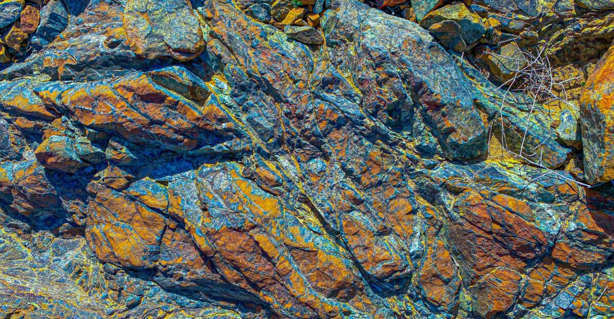 a close up of a rock with yellow and blue colors