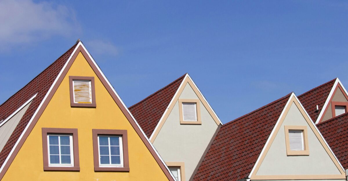 a row of houses with a blue sky in the background