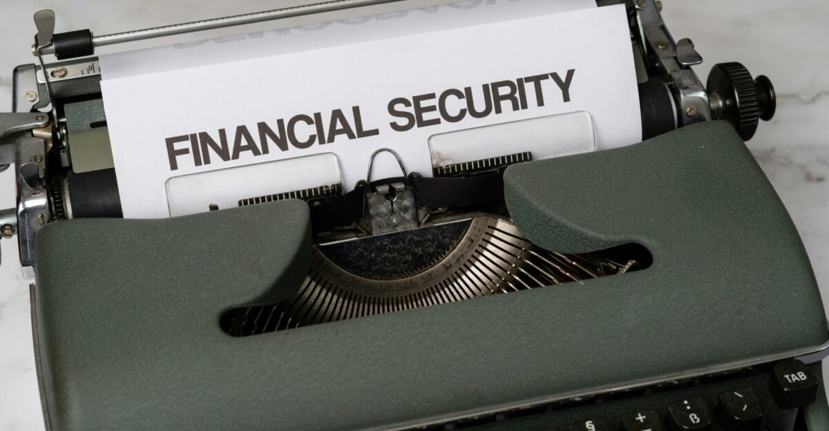 a close up of a typewriter with a financial security sign on it