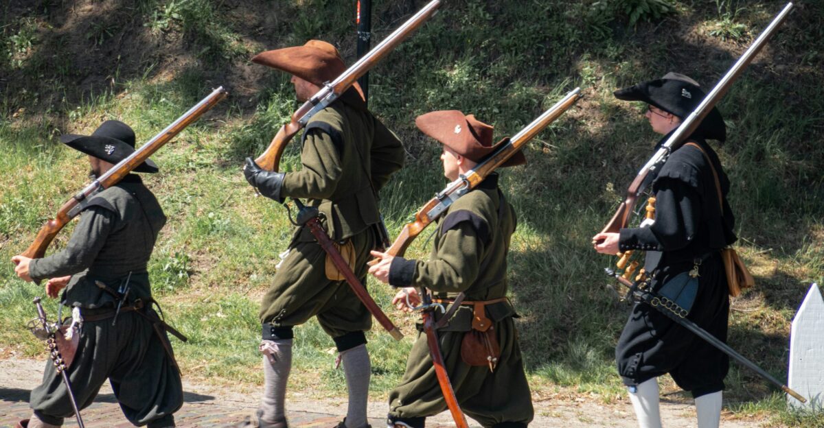 a group of men in military uniforms holding rifles