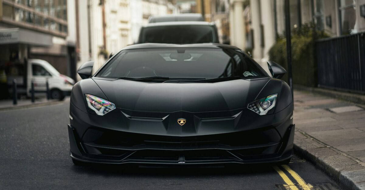 a black car parked on the side of a street