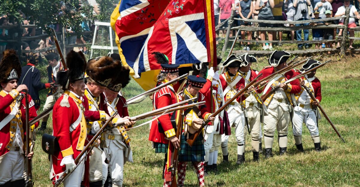a group of people in uniform holding flags and a flag