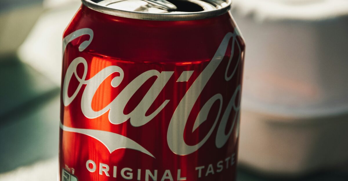 a can of coca cola sitting on top of a table