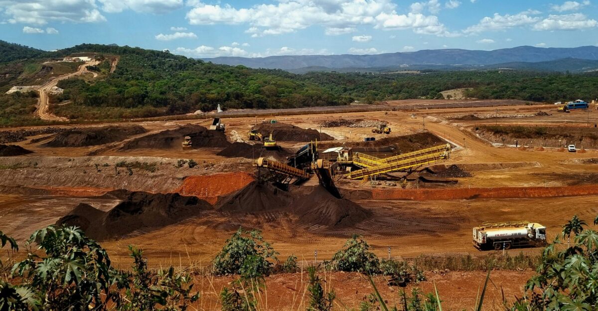 a construction site with a large amount of dirt in the foreground