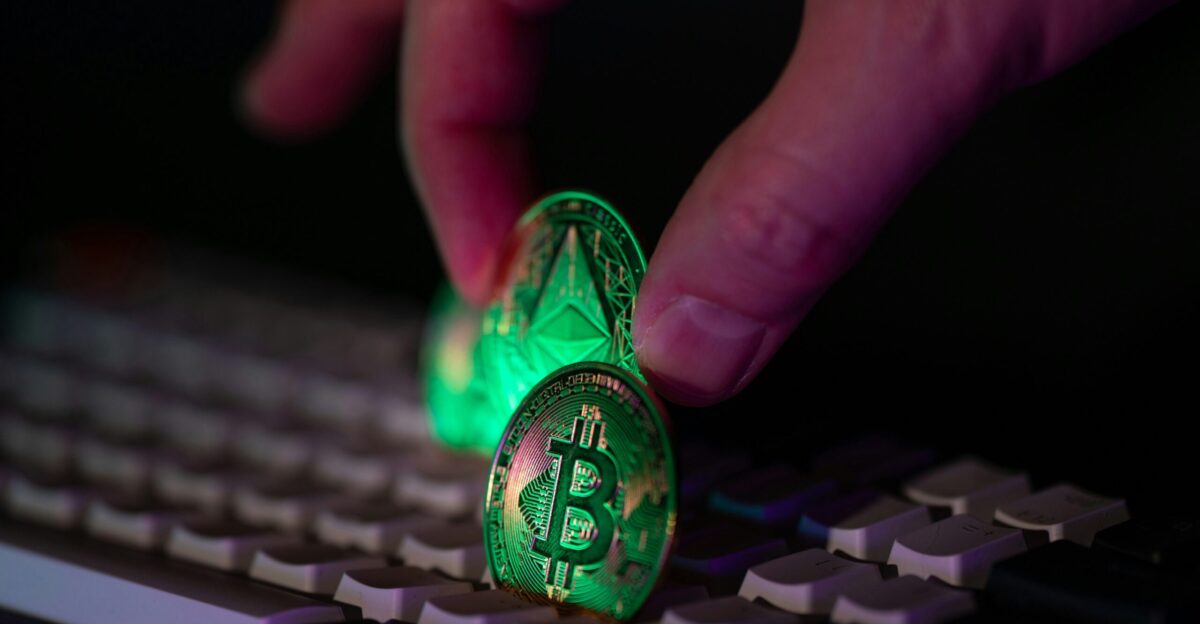 Hand placing glowing crypto coins on a keyboard