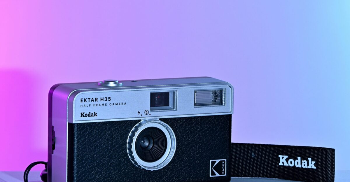 A vintage kodak camera with strap is shown