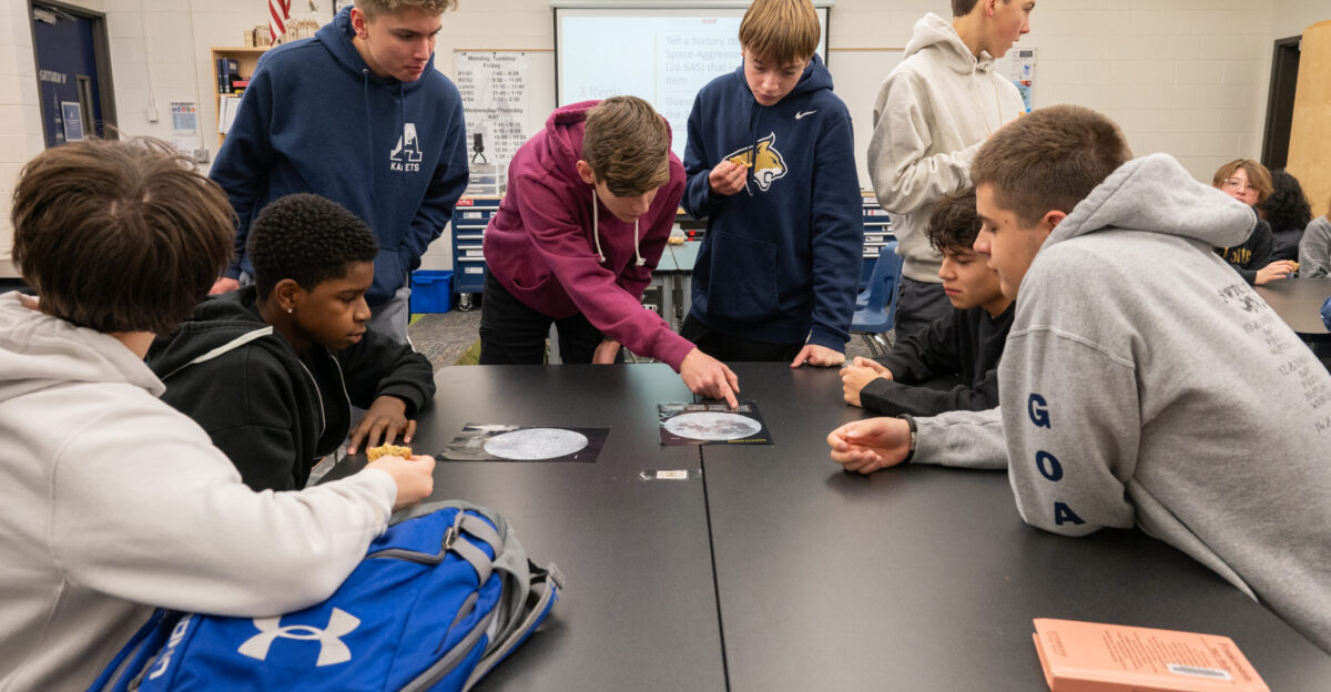 Students in the Introduction to Aviation and Aerospace class analyze an object related to 26th Space Aggressor Squadron history at Air Academy High School Colorado Jan 14 2025 The 310th Space Wing facilitated presentations and activities for the students during a community outreach event focused on 26th Space Aggressor Squadron history and current mission The event is part of the Wing s Year of Heritage initiative to educate the community on the history and contributions of the Wing U S Air Force photo by Tech Sgt Marko Salopek