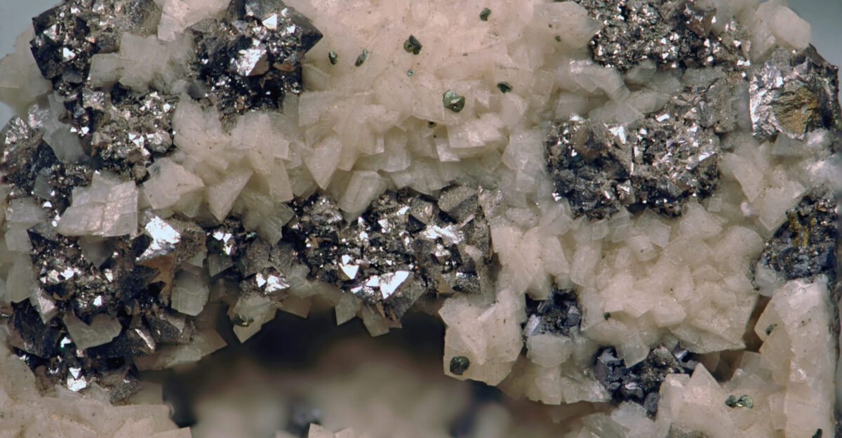 Arsenopyrite-dolomite from Mexico field of view 3 7 cm across Silvery-colored crystals arsenopyrite Pale pink crystals dolomite CaMg CO3 2 - calcium magnesium carbonate A mineral is a naturally-occurring solid inorganic crystalline substance having a fairly definite chemical composition and having fairly definite physical properties At its simplest a mineral is a naturally-occurring solid chemical Currently there are over 4900 named and described minerals - about 200 of them are common and about 20 of them are very common Mineral classification is based on anion chemistry Major categories of minerals are elements sulfides oxides halides carbonates sulfates phosphates and silicates The sulfide minerals contain one or more sulfide anions S-2 The sulfides are usually considered together with the arsenide minerals the sulfarsenide minerals and the telluride minerals Many sulfides are economically significant as they occur commonly in ores The metals that combine with S-2 are mainly Fe Cu Ni Ag etc Most sulfides have a metallic luster are moderately soft and are noticeably heavy for their size These minerals will not form in the presence of free oxygen Under an oxygen-rich atmosphere sulfide minerals tend to chemically weather to various oxide and hydroxide minerals Arsenopyrite has as the name suggests the chemistry of pyrite iron sulfide plus some arsenic Arsenopyrite is FeAsS - iron arsenic sulfide It is the most common arsenic-bearing mineral on Earth It has a metallic luster silvery color blackish streak and a hardness of about 5 5 to 6 When heated it gives off a garlic smell the smell of arsenic Locality Santa Eulalia Mining District Chihuahua State northern Mexico Photo gallery of arsenopyrite