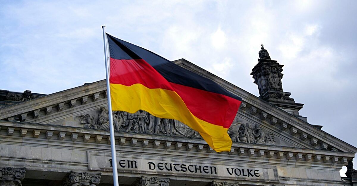 German national flag waving in front of the Reichstag building in Berlin a symbol of democracy
