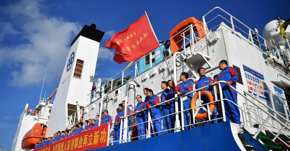 Researchers on a vessel in Sanya China prepare for a maritime expedition under a clear blue sky