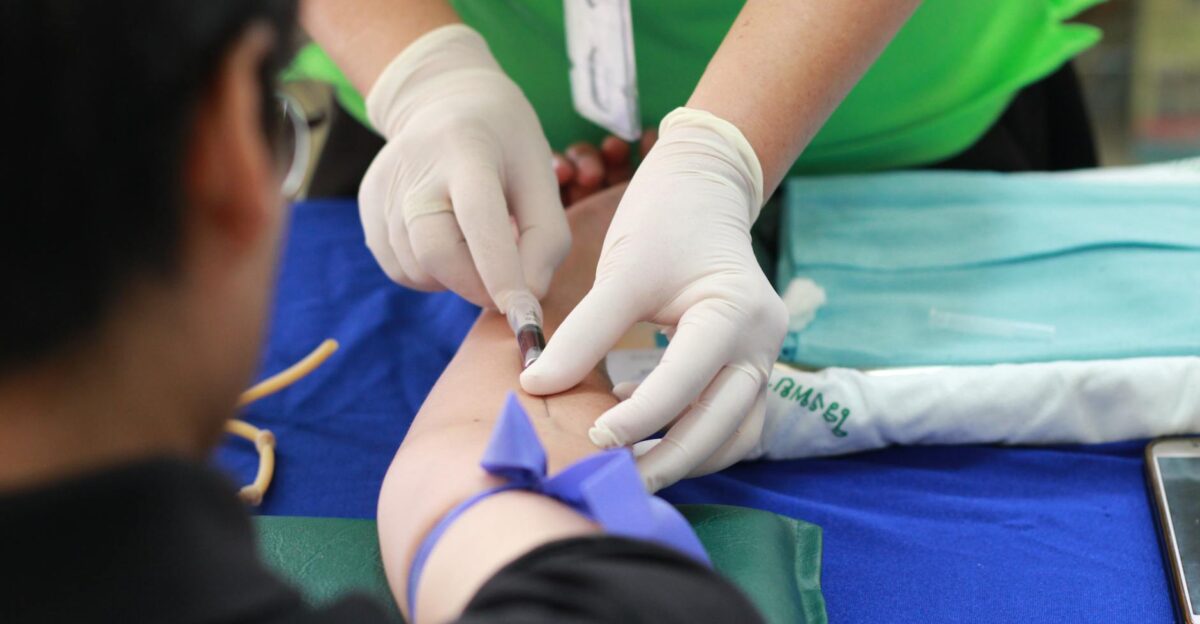 A healthcare professional administering an injection to a patient s arm during a medical procedure