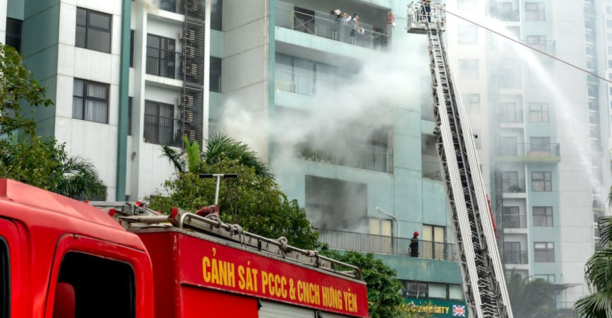 Firefighters use ladder and hose to extinguish fire in tall building