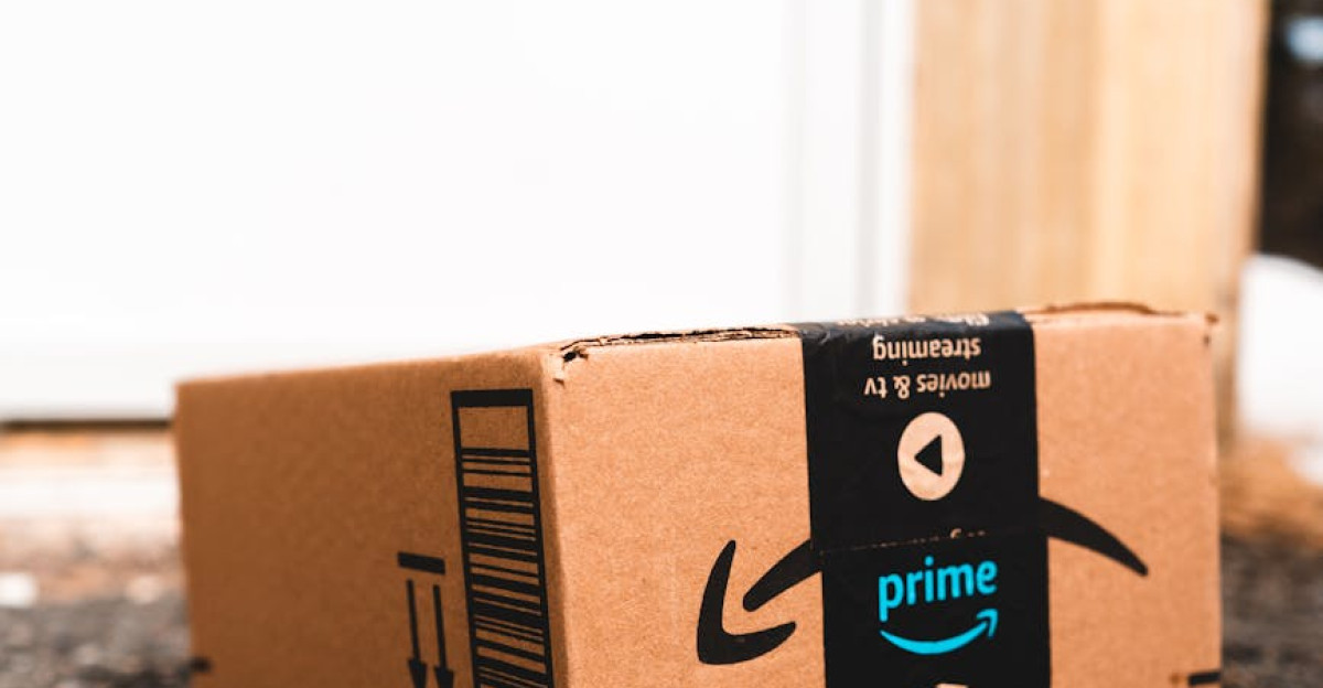 A cardboard box marked with Prime logo placed outside on a porch ready for delivery