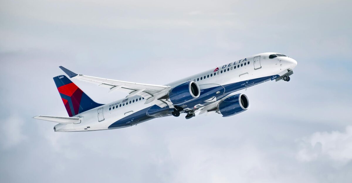A Delta Air Lines aircraft flying high above clouds showcasing modern aviation technology