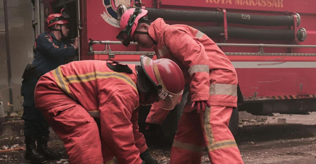 Firefighters working diligently during a street emergency in Makassar Indonesia showcasing teamwork and bravery