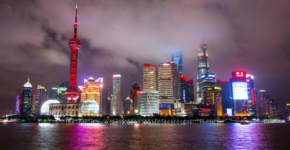 Captivating view of Shanghai s illuminated skyline reflecting on the waterfront at night