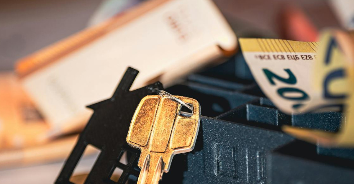 Close-up of house keys euro bills and charts symbolizing real estate investment and finance