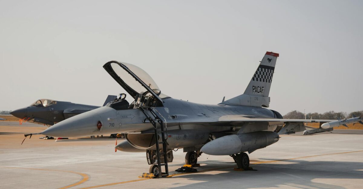 A military fighter jet stationed on an open runway during an air show showcasing advanced aviation technology