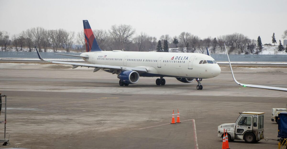 Delta airplane preparing for departure at a snowy Minnesota airport