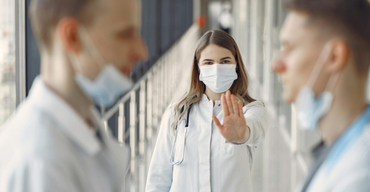 Doctors in masks demonstrating healthcare safety and teamwork indoors