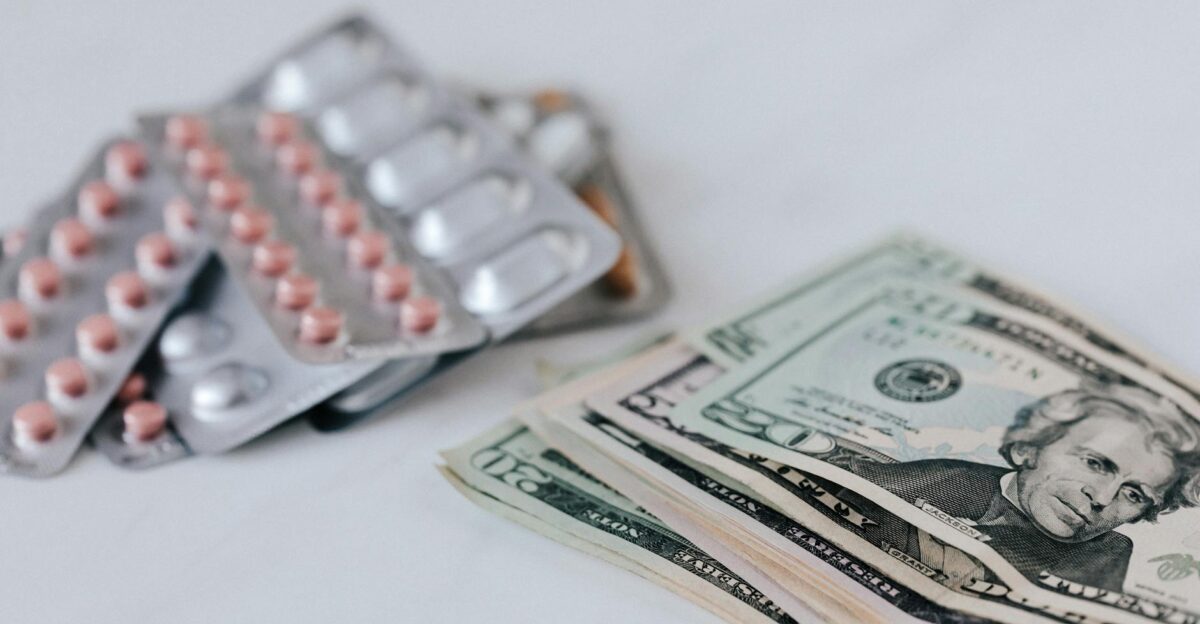 Close-up of pills and cash representing healthcare expenses and medication costs
