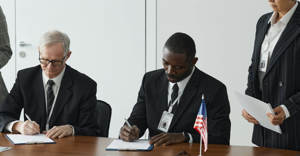 Business leaders signing a significant agreement in a conference room setting