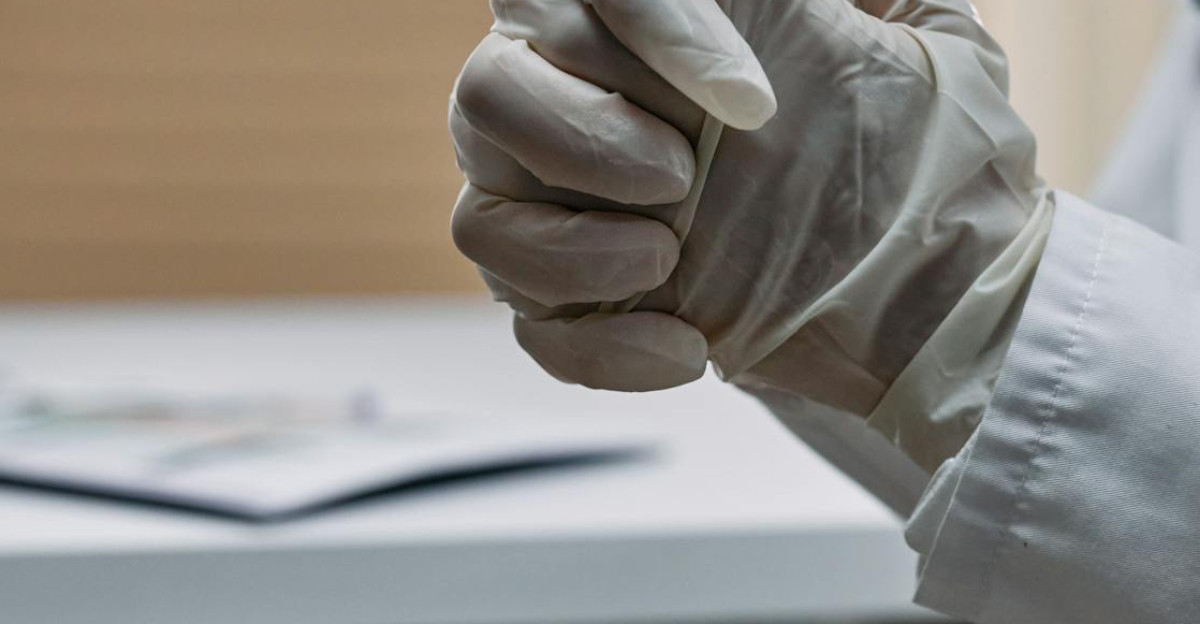 Close-up of a medical professional s hands wearing latex gloves in a clinical setting