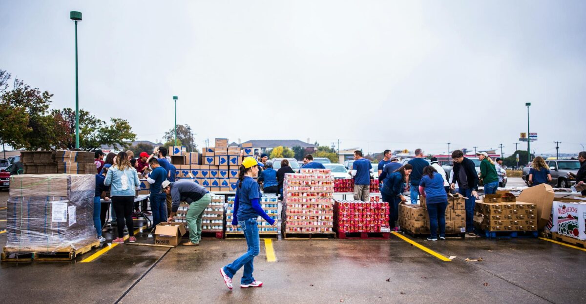 Full body of young female employee of terminal port coming to delivered containers of cargo