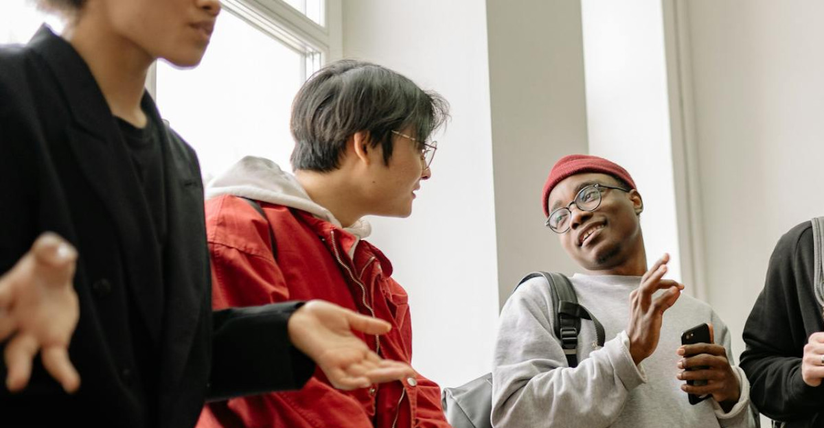A lively group of diverse students chatting and interacting indoors